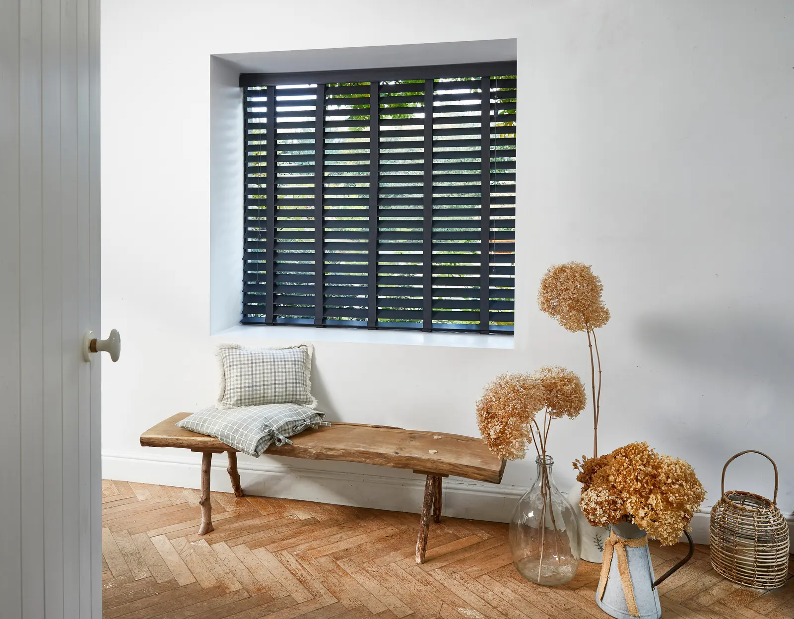 Dark wooden slat blinds over a window seat with timber panelling – Acocks Green Blinds